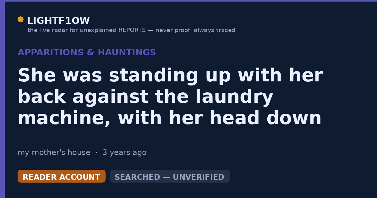 She was standing up with her back against the laundry machine, with her head down and long hair dangling at the sides.